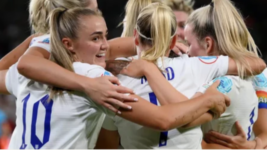 lioness team hugging